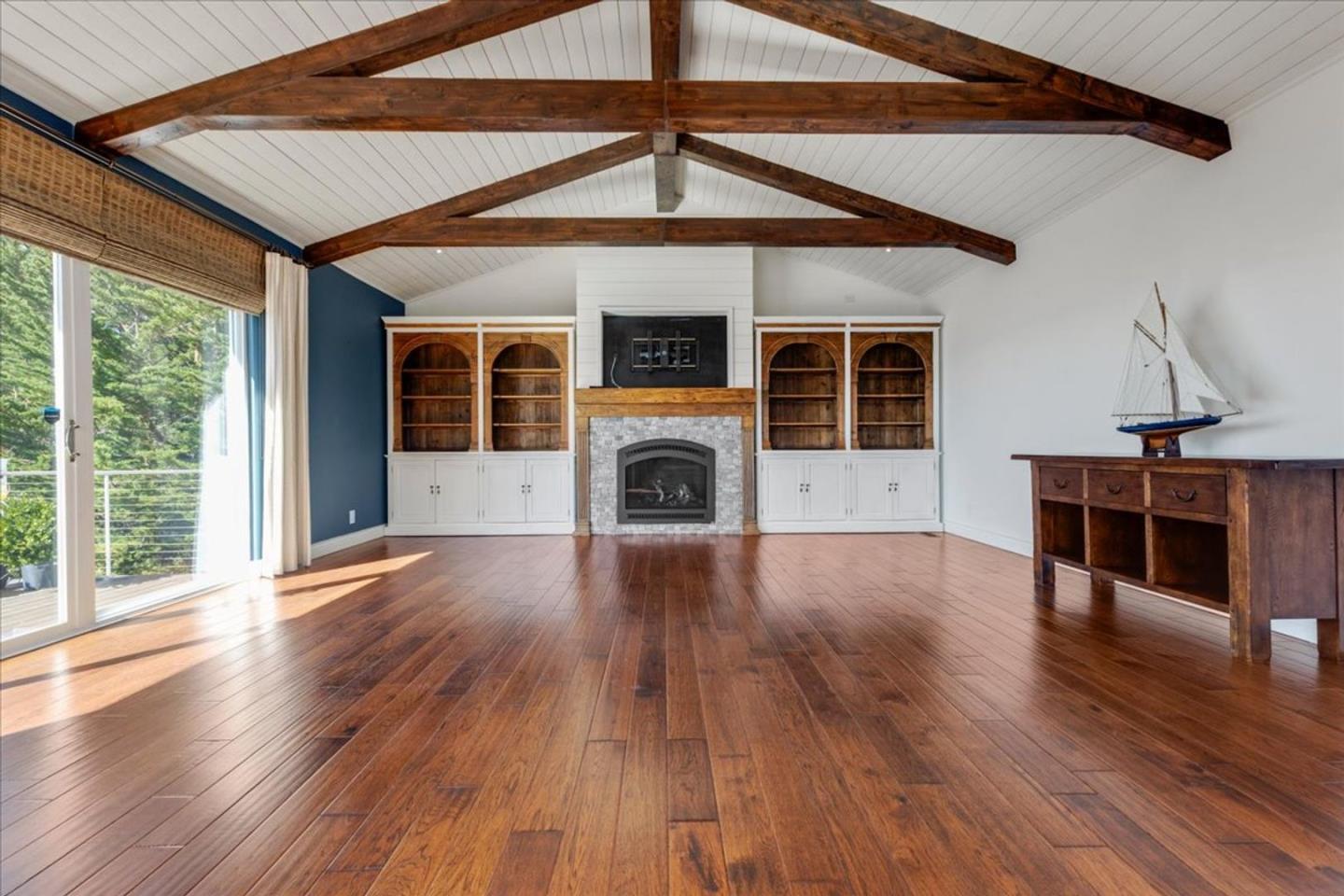 15 Mentone Road Carmel, CA 93923 - Photo 13 of 47 a view of empty room with wooden floor and fireplace
