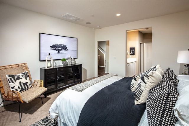 a bedroom with bed and a couch