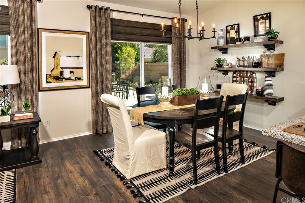 44402 Beringer Drive Indio, CA 92203 - Photo 6 of 18 a dining room with furniture a chandelier and wooden floor