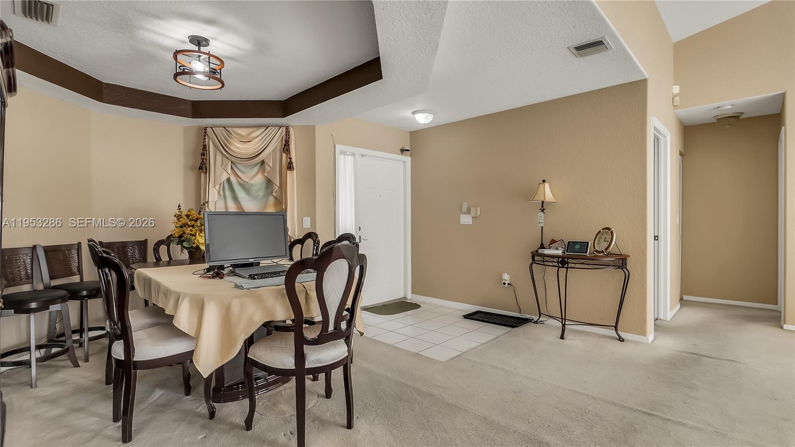 15486 Southwest 147th Street Miami, FL 33196 - Photo 13 of 30 a view of a dining room with furniture and a chandelier