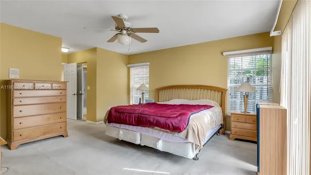 a spacious bedroom with a bed and a dresser