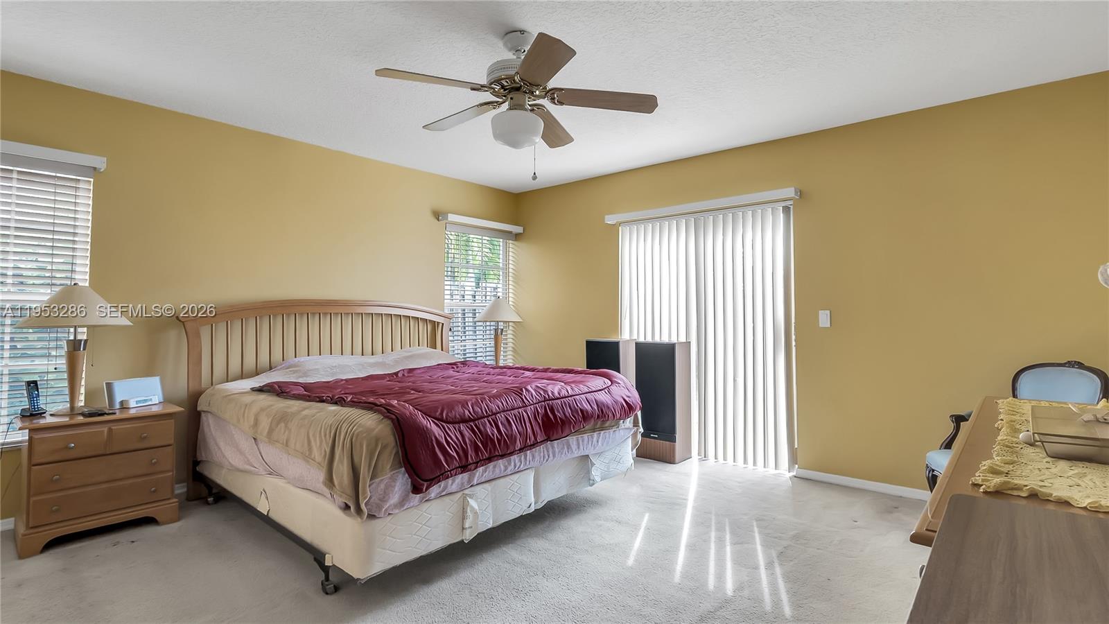 15486 Southwest 147th Street Miami, FL 33196 - Photo 15 of 30 a spacious bedroom with a bed and a chandelier