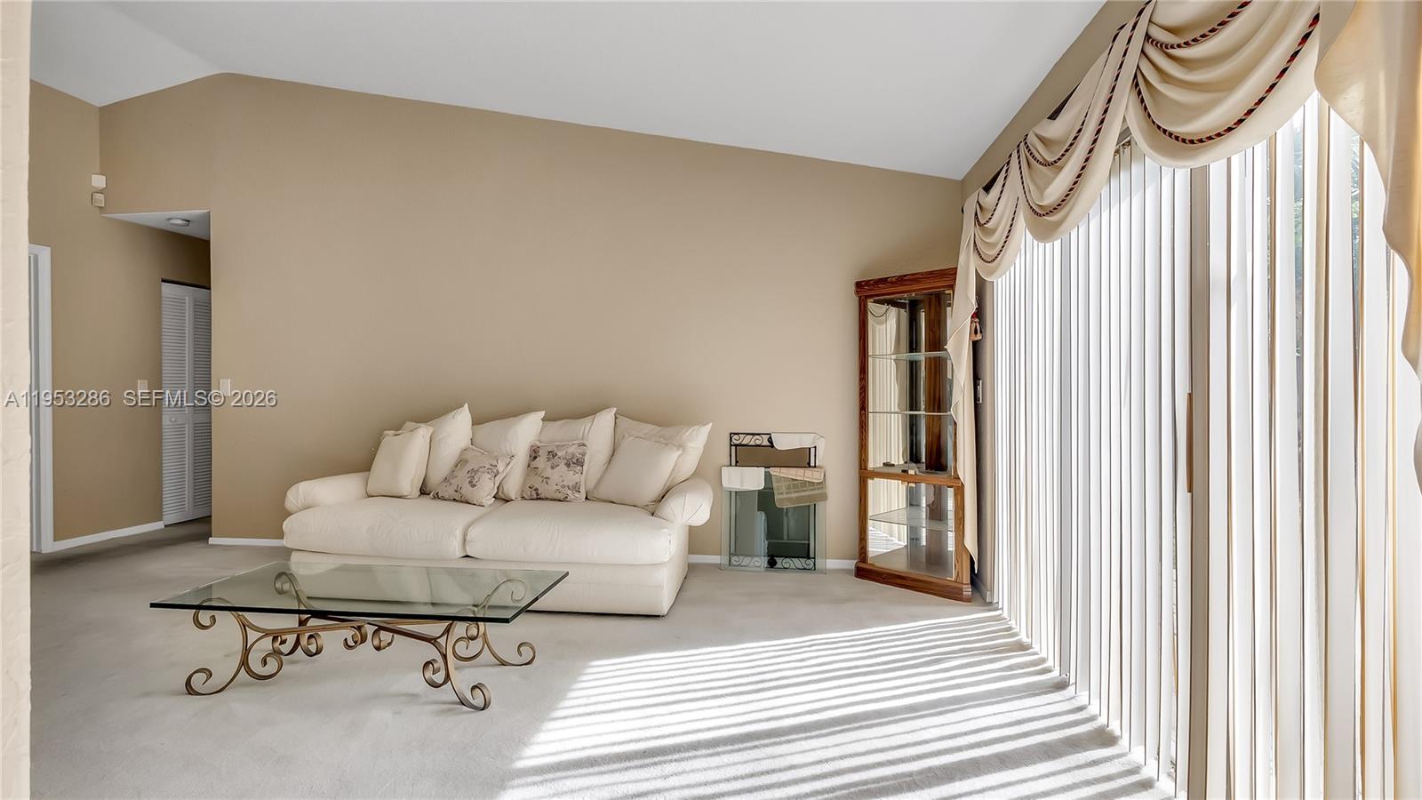 15486 Southwest 147th Street Miami, FL 33196 - Photo 3 of 30 a spacious bedroom with a bed and a table in it