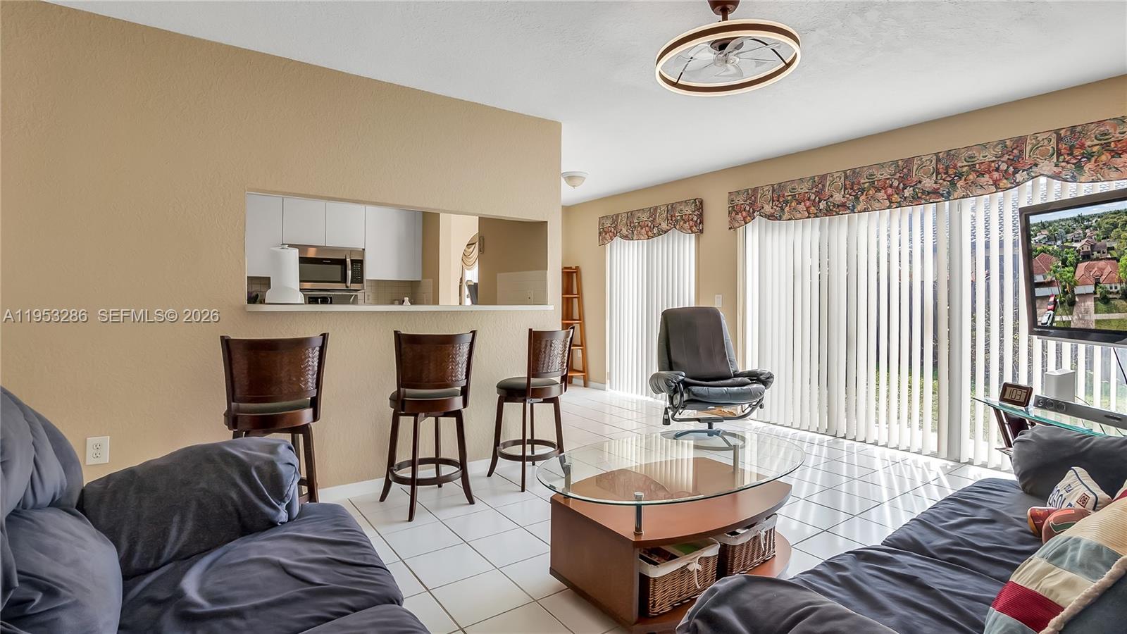 15486 Southwest 147th Street Miami, FL 33196 - Photo 8 of 30 a living room with furniture and a flat screen tv