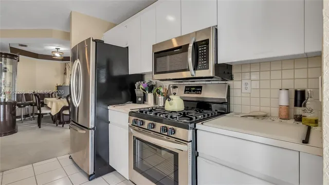 a kitchen with a stove and a refrigerator