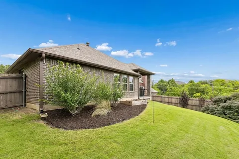 a view of a house with a big yard and potted plants