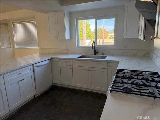 a kitchen with sink and window