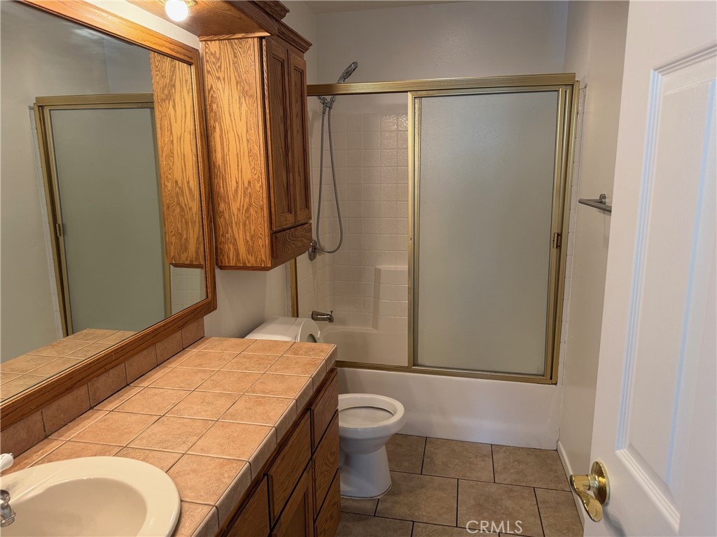 723 Ford Street Corona, CA 92879 - Photo 17 of 36 a bathroom with a granite countertop sink toilet and shower