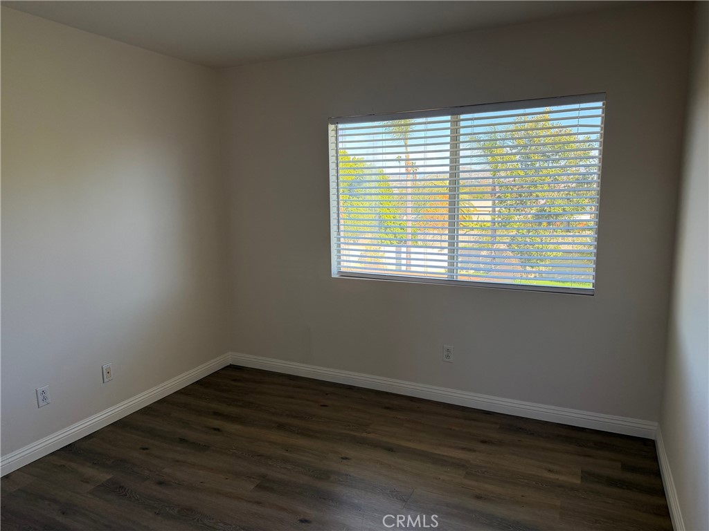 723 Ford Street Corona, CA 92879 - Photo 19 of 36 a view of an empty room with wooden floor and a window