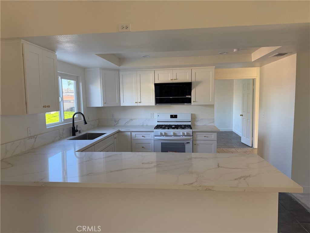 723 Ford Street Corona, CA 92879 - Photo 8 of 36 a kitchen with stainless steel appliances a stove a microwave and a refrigerator