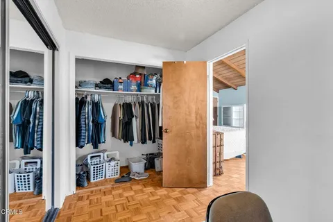 a living room with furniture a rug and a large window