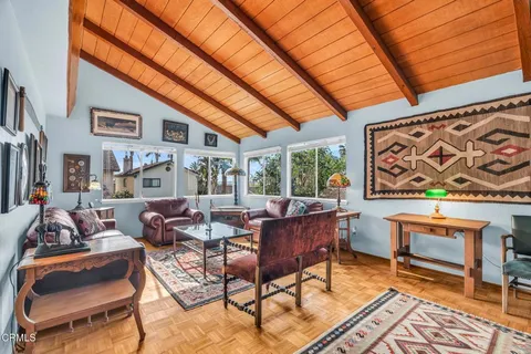 a living room with furniture and a rug