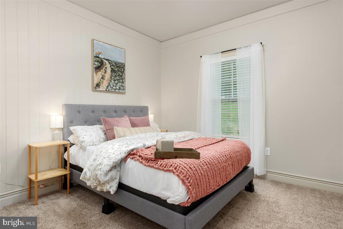 2390 Shirley Road Charles Town, WV 25414 - Photo 39 of 69 a bedroom with a bed lamp and a window