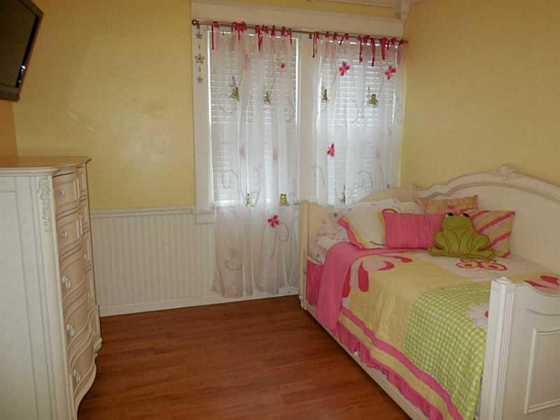 1301 Pine Hollow Road McKees Rocks, PA 15136 - Photo 17 of 24 Bedroom. A cheerful bedroom with beadboard trim and laminate flooring.