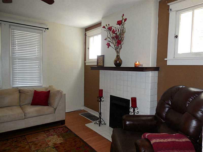 1301 Pine Hollow Road McKees Rocks, PA 15136 - Photo 4 of 24 Living Room. Neutral decor in the formal living room. Laminate flooring and a decorative fireplace as a focal point. Ceiling fan and lots of windows for natural light.