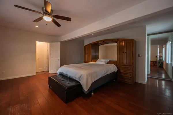a bathroom with a granite countertop sink a mirror and a shower