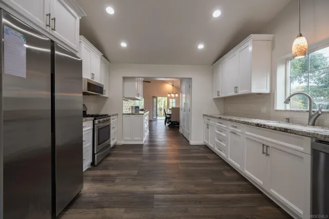 a view of a house with swimming pool and sitting area