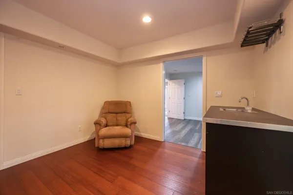 a kitchen with refrigerator and chairs