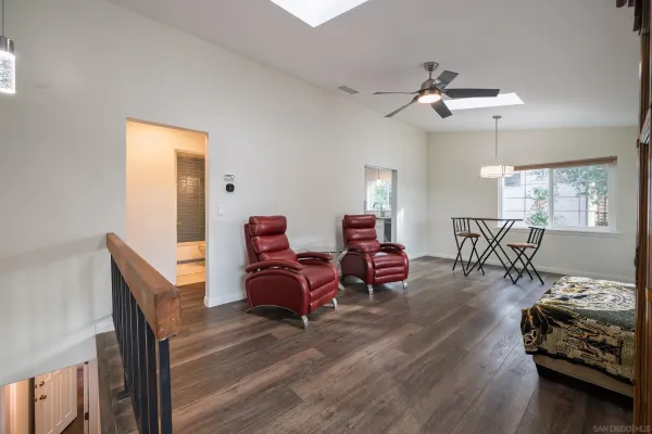 a view of a dining room with furniture and chandelier