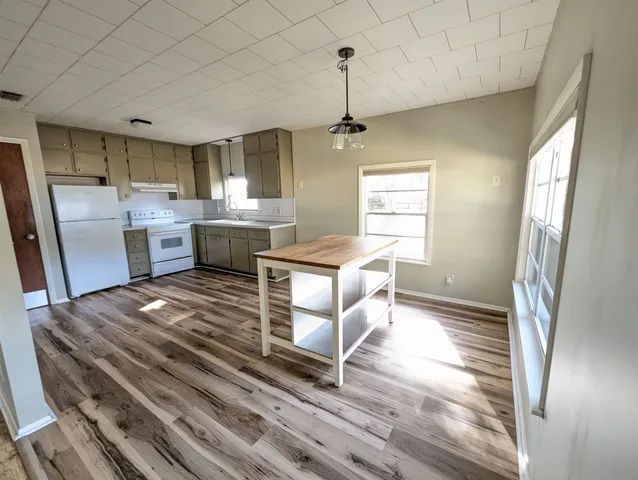a open kitchen with a sink stainless steel appliances and counter space