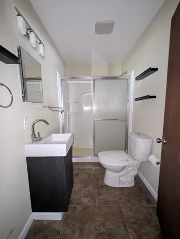 a bathroom with a sink toilet and shower