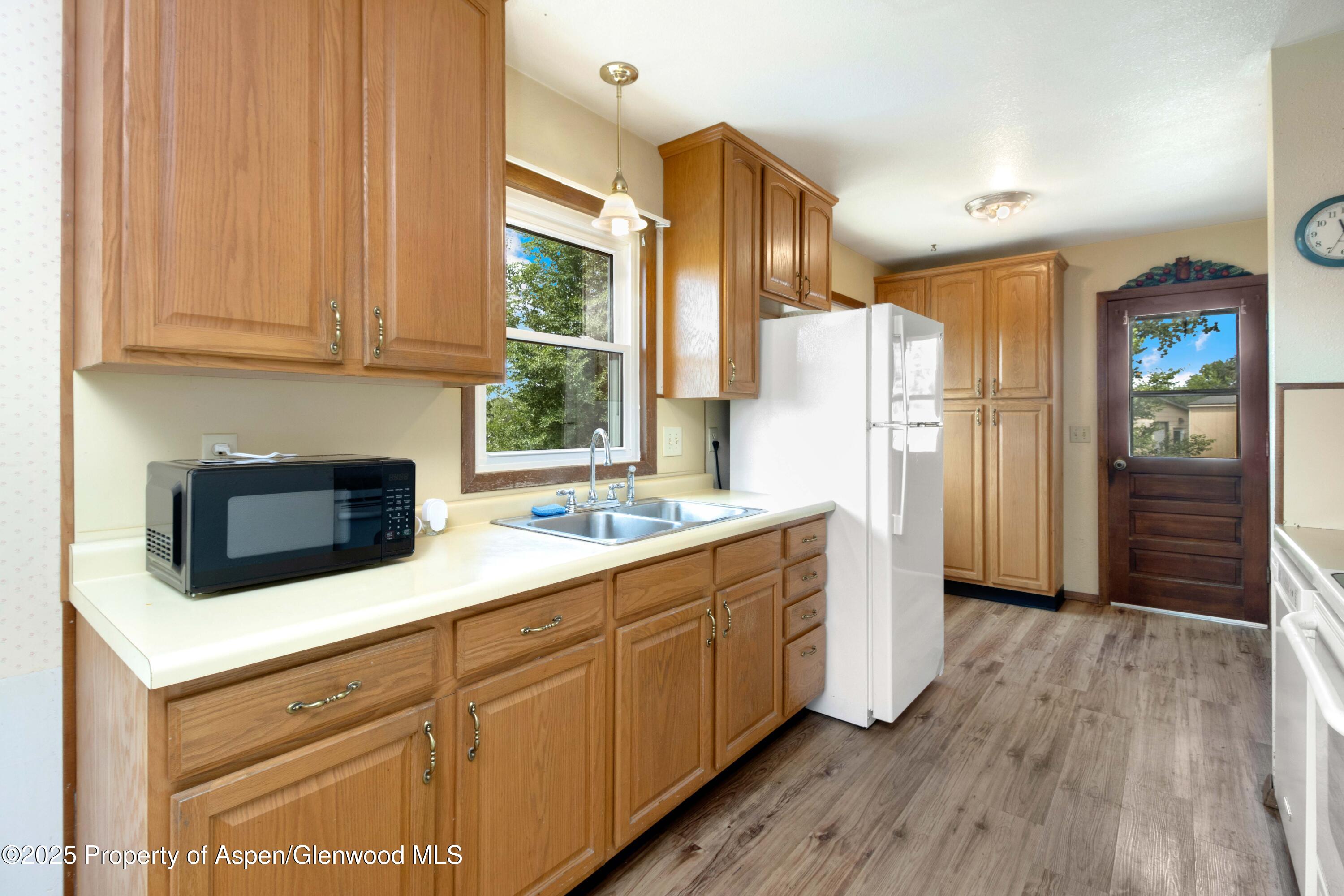 12303 West Spring Circle Eckert, CO 81418 - Photo 14 of 30 a kitchen with a refrigerator sink and cabinets