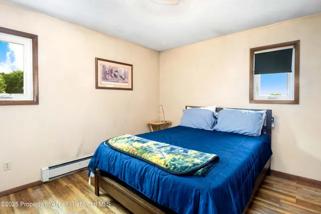 a bed sitting in a bedroom next to a window