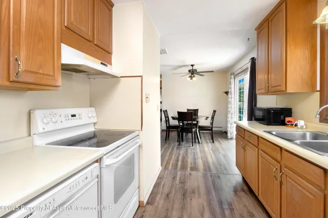 a kitchen with a sink a counter top space cabinets and appliances