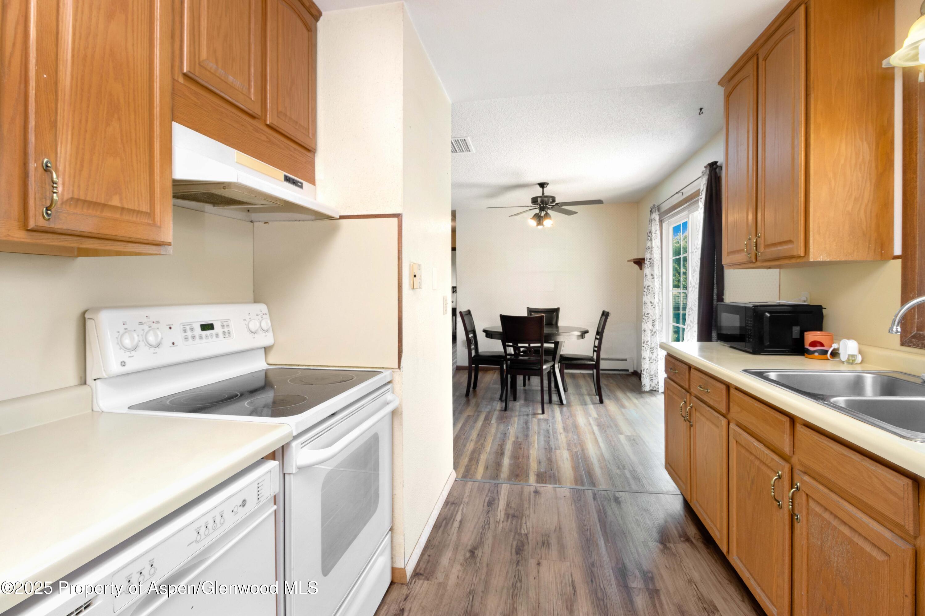 12303 West Spring Circle Eckert, CO 81418 - Photo 8 of 30 a kitchen with a sink a counter top space cabinets and appliances