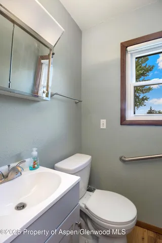a white toilet sitting next to a bathroom sink