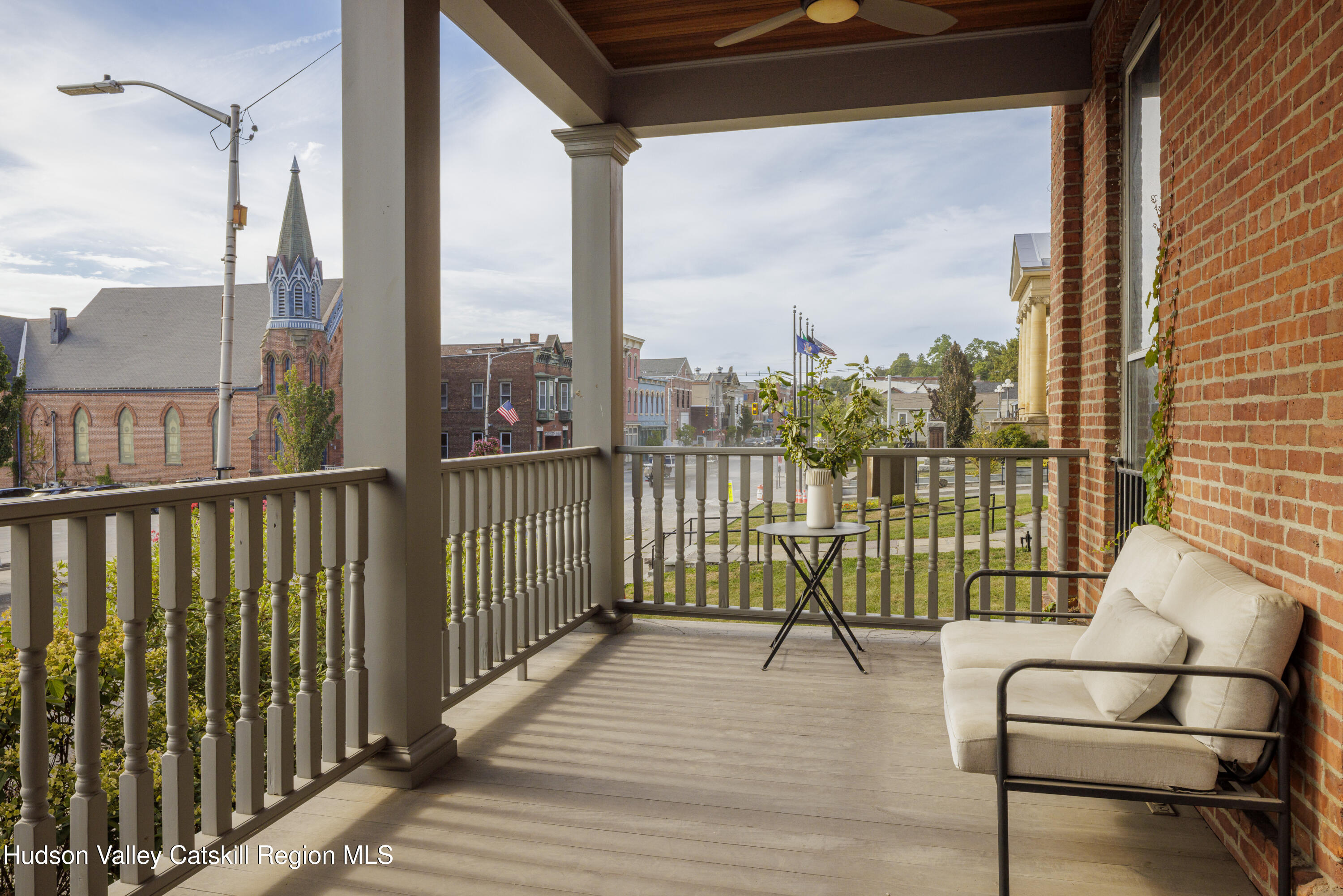 308 Main Street Catskill, NY 12414 - Photo 26 of 30 a view of a balcony with wooden floor next to a iron stairs
