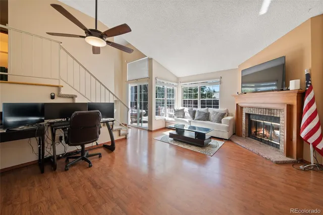 a living room with furniture fireplace and flat screen tv