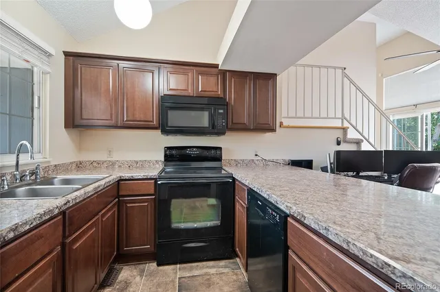 a kitchen with a sink stove and microwave