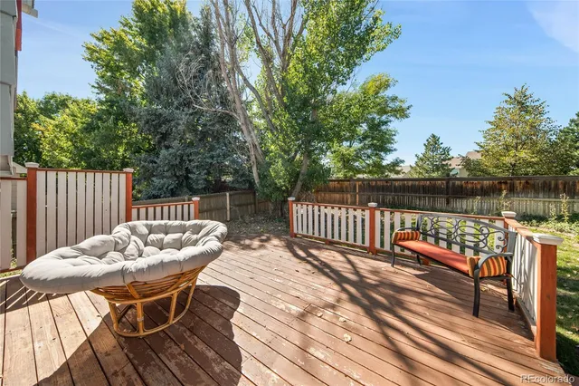 a view of a wooden deck with furniture
