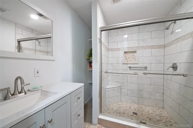 a bathroom with a shower sink and mirror