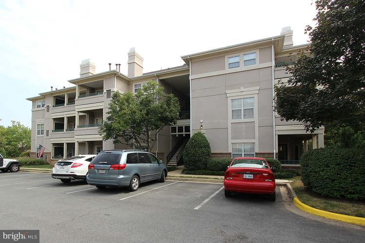 12009 Taliesin Place, Unit 14 Reston, VA 20190 - Photo 2 of 15 a car parked in front of a building