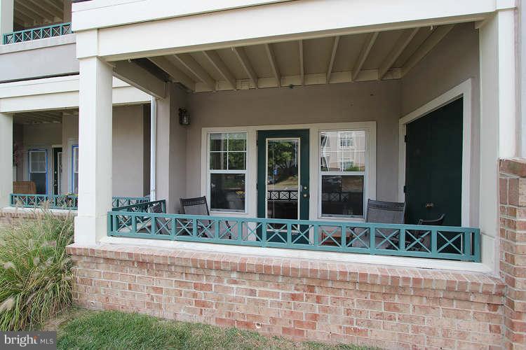 12009 Taliesin Place, Unit 14 Reston, VA 20190 - Photo 11 of 15 a front view of a house with garden