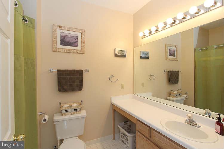 12009 Taliesin Place, Unit 14 Reston, VA 20190 - Photo 8 of 15 a bathroom with a sink mirror toilet and shower