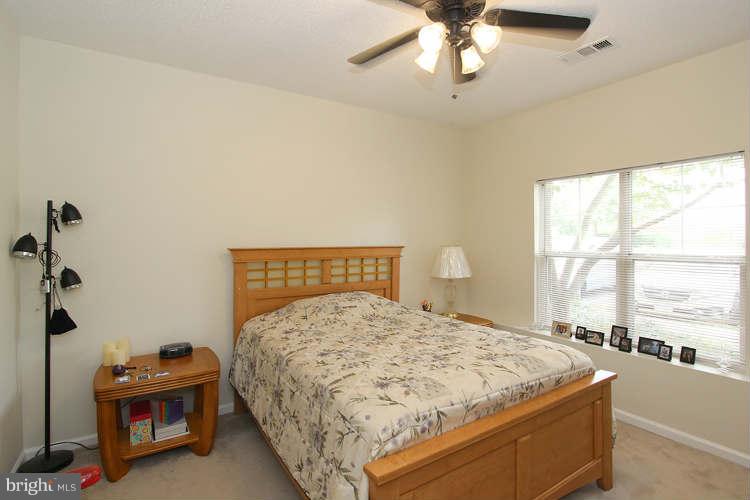 12009 Taliesin Place, Unit 14 Reston, VA 20190 - Photo 9 of 15 a bedroom with a bed and a window