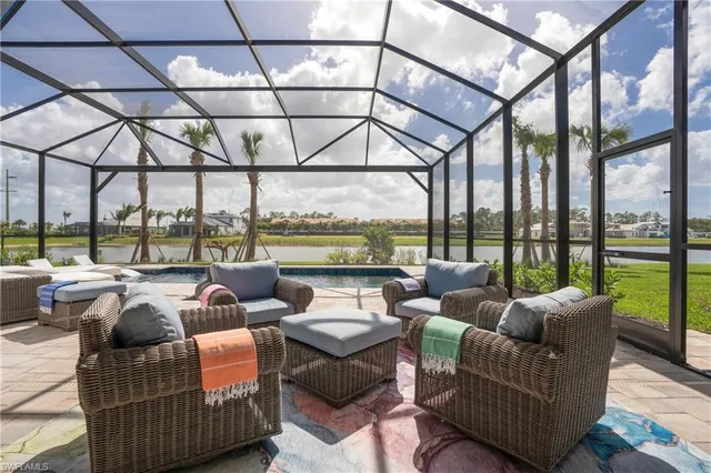 a living room with furniture and a floor to ceiling window