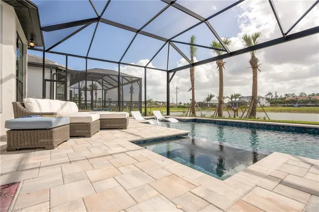 a outdoor patio with swimming pool and sitting space