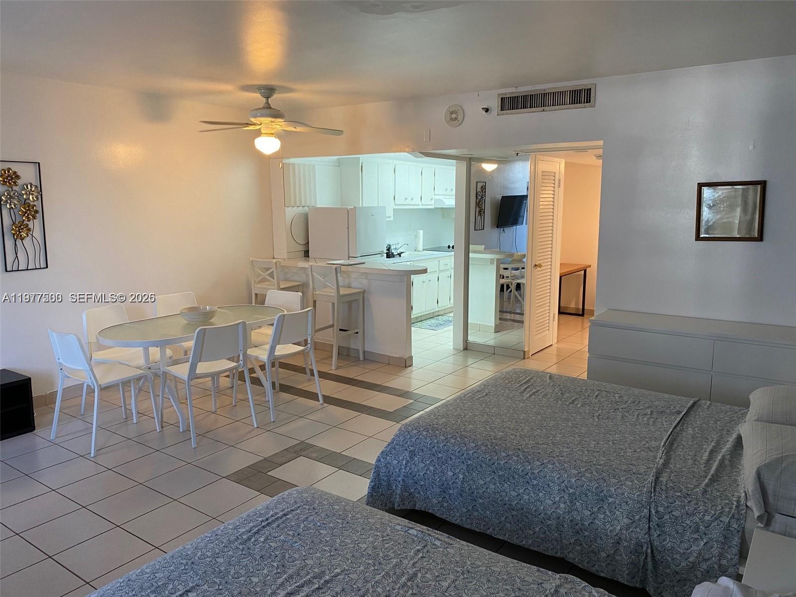 100 Lincoln Road, Unit 304 Miami Beach, FL 33139 - Photo 2 of 8 a living room with furniture a table and kitchen view