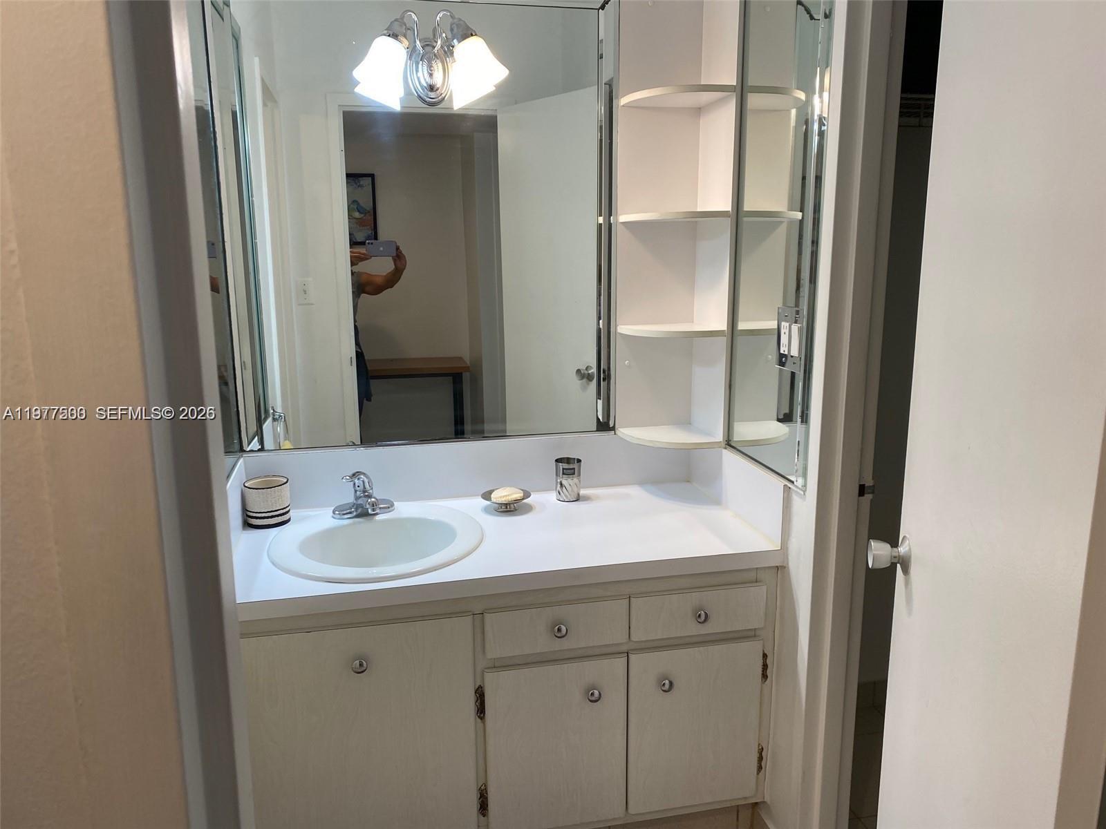 100 Lincoln Road, Unit 304 Miami Beach, FL 33139 - Photo 4 of 8 a bathroom with a sink and a mirror