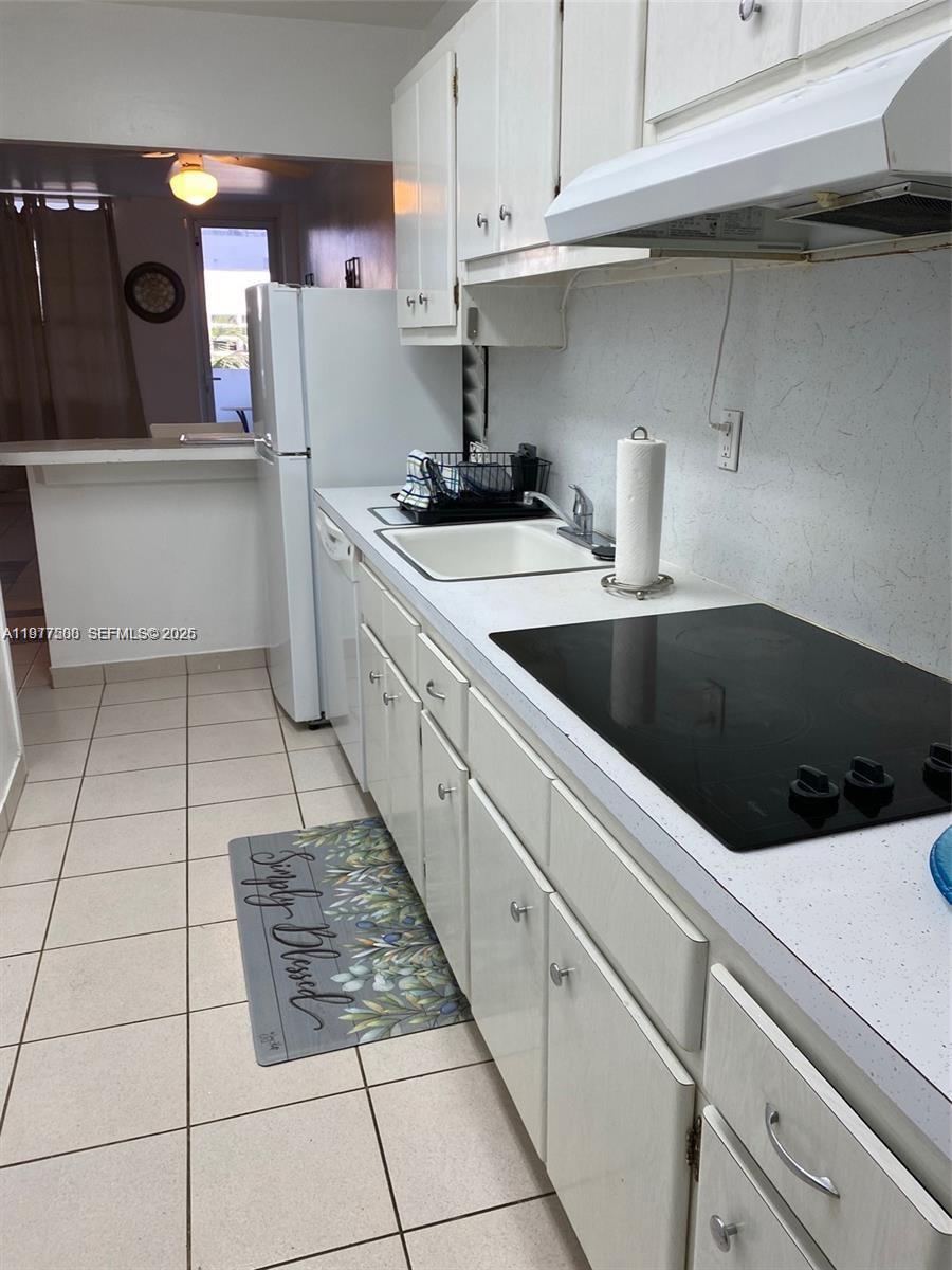100 Lincoln Road, Unit 304 Miami Beach, FL 33139 - Photo 5 of 8 a kitchen with a sink and cabinets