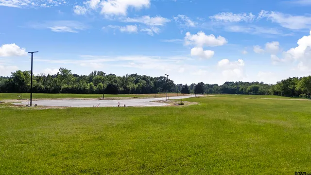 a view of a swimming pool and a yard