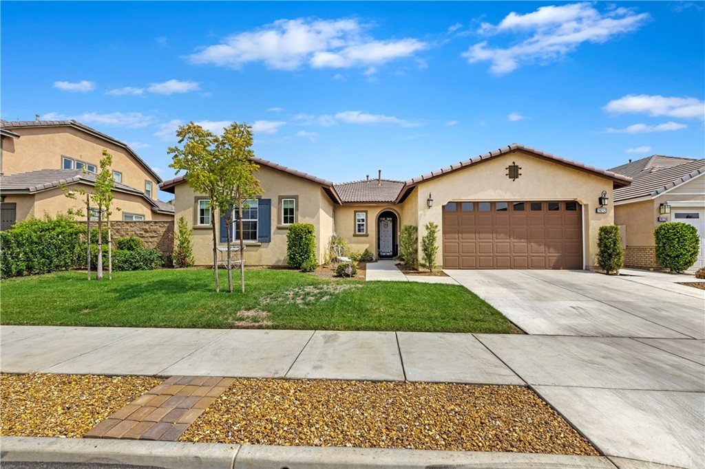 a front view of a house with a yard and garage