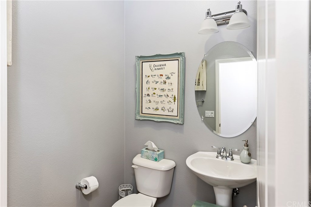28212 Rustling Wind Circle Menifee, CA 92585 - Photo 11 of 28 a bathroom with a toilet a sink and mirror