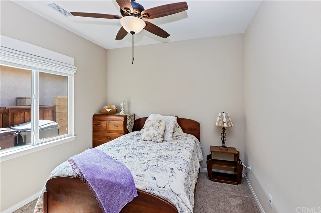 28212 Rustling Wind Circle Menifee, CA 92585 - Photo 12 of 28 a bedroom with a bed and wooden floor