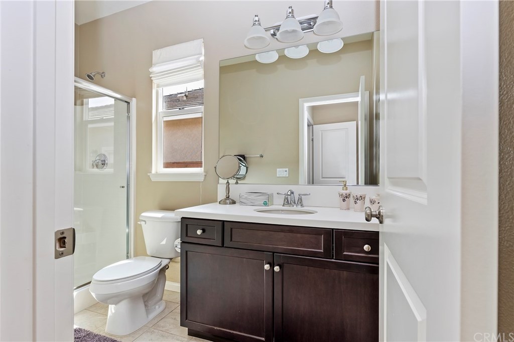 28212 Rustling Wind Circle Menifee, CA 92585 - Photo 14 of 28 a bathroom with a toilet a sink and mirror