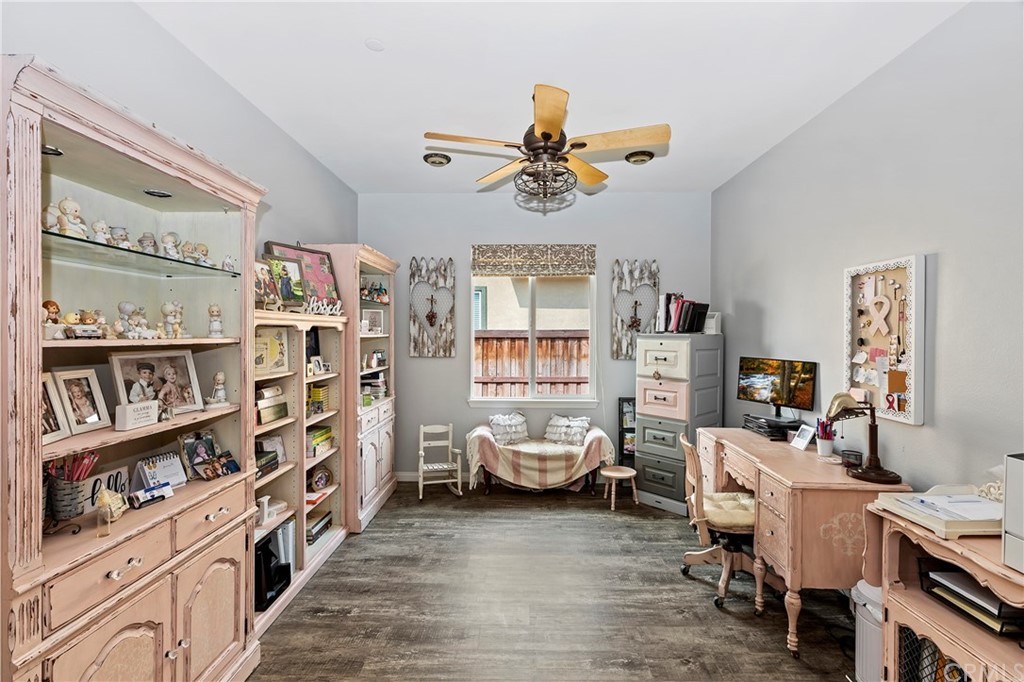 28212 Rustling Wind Circle Menifee, CA 92585 - Photo 20 of 28 a living room with furniture and a book shelf